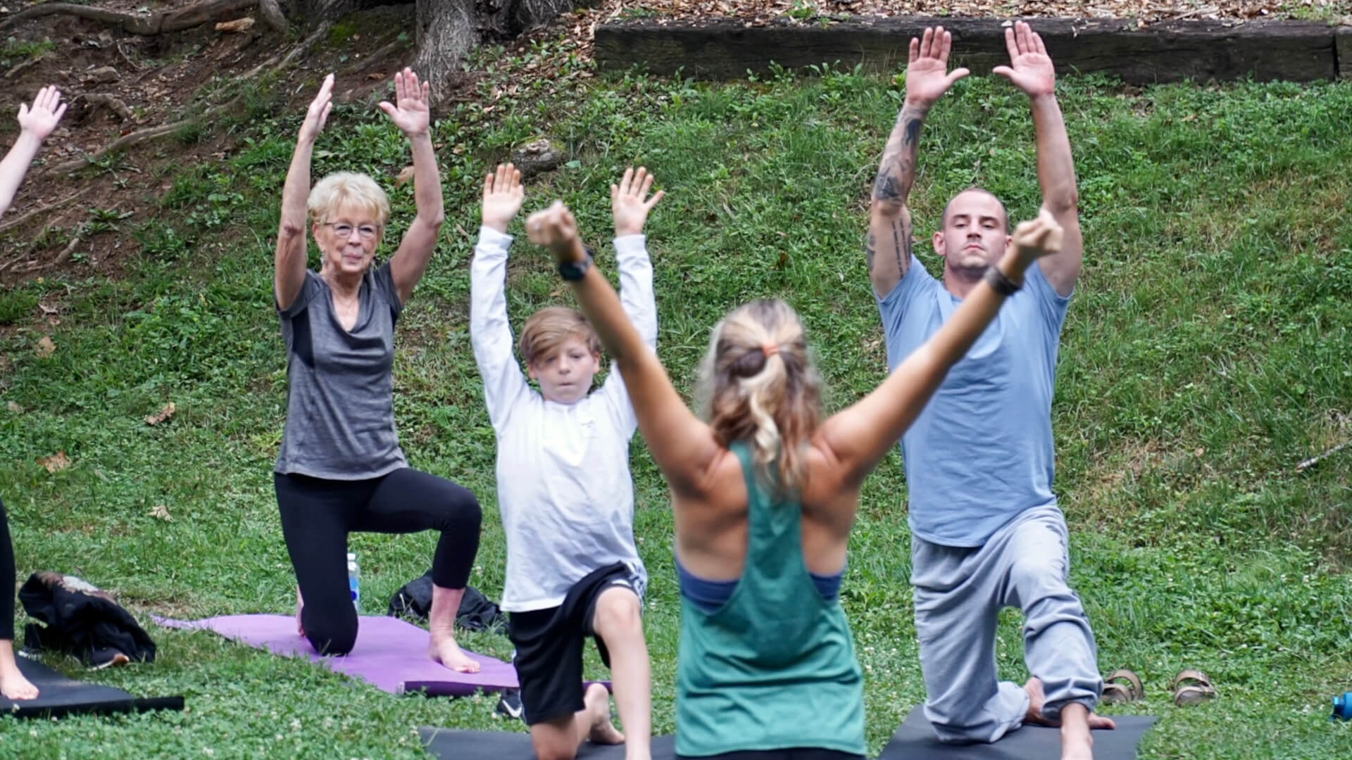 Asheville Wedding attendees perform yoga poses during a wedding day wellness session.