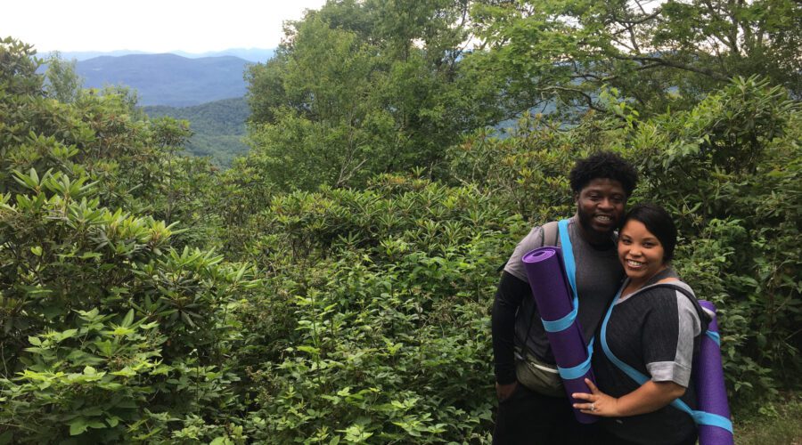Couple posing on a yoga hike outside Asheville on a couples retreat with Asheville Wellness Tour.